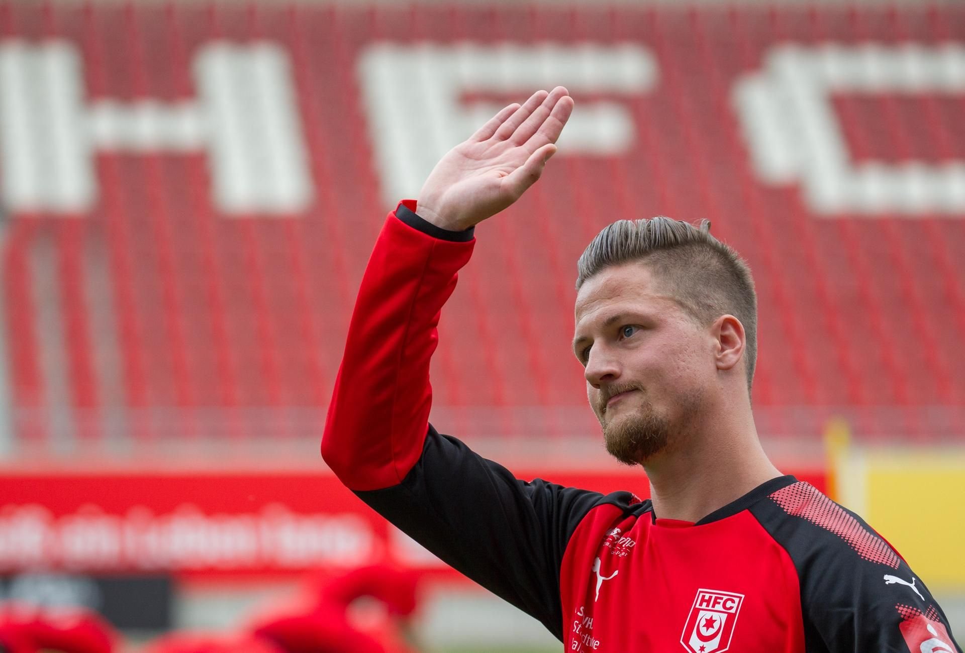 Hendrik Starostzik winkt beim Trainingsauftakt den HFC-Fans auf der Tribüne zu.