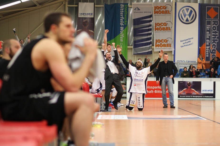 Gesten des Jubels: Co-Trainer Marcus Brambora (l.) und Center Adrian Hill (am Boden) reißen die Arme nach oben.
