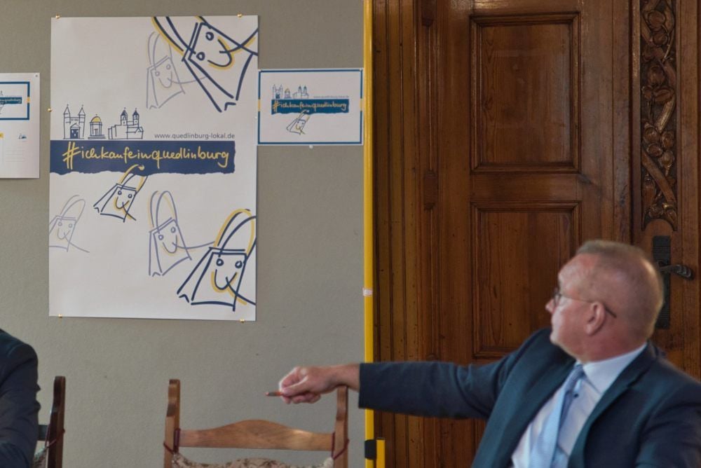 Oberbürgermeister Frank Ruch weist auf das Werbematerial für die Kampagne, zu dem auch Plakate und Postkarten gehören.