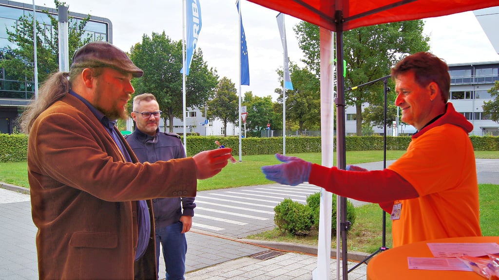 Felix Heimberg (l.) lässt sich am Stand von Roger Altenburg typisieren. Er hofft, dass Menschen auch helfen würden, wenn seine Familie betroffen wäre.