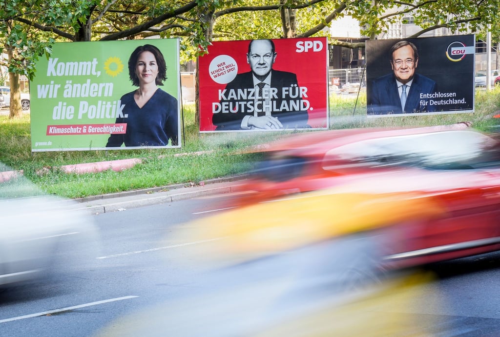 Autos fahren an den Wahlplakaten von Bündnis 90/Die Grünen (l-r) mit Kanzlerkandidatin Annalena Baerbock, SPD mit Kanzlerkandidaten Olaf Scholz und CDU mit Kanzlerkandidaten Armin Laschet vorbei.