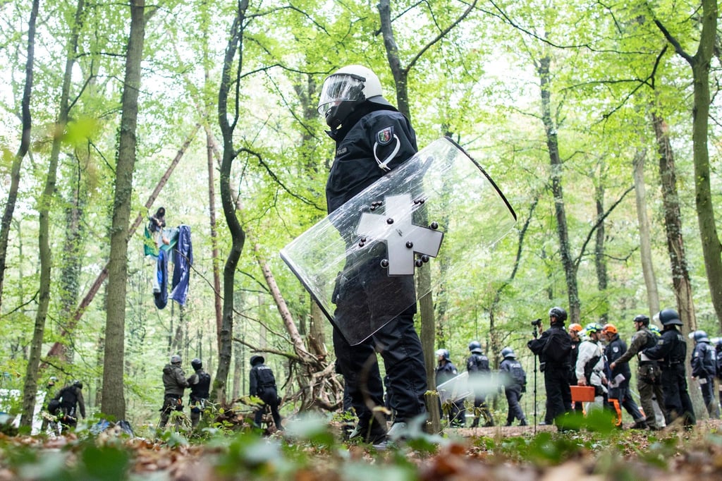 Polizisten stehen im September 2018 vor einer Barrikade im Hambacher Forst, in der sich eine Aktivistin festgebunden hat.