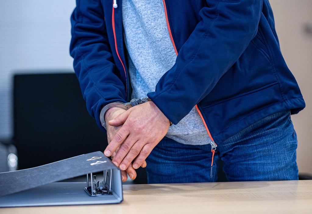 Beim Auftakt eines erneuten Prozesses vor dem Landgericht Osnabrück steht der wegen Mordes an einer Studentin 2015 im Klosterwald bei Loccum Angeklagte mit Handschellen im Sitzungssaal.