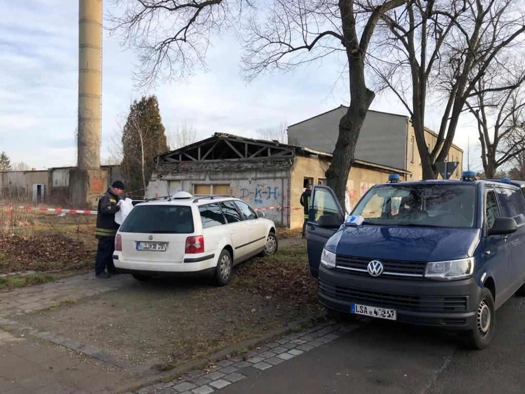 Polizeifahrzeuge stehen vor dem Gebäude, in dem die Leiche gefunden wurde.