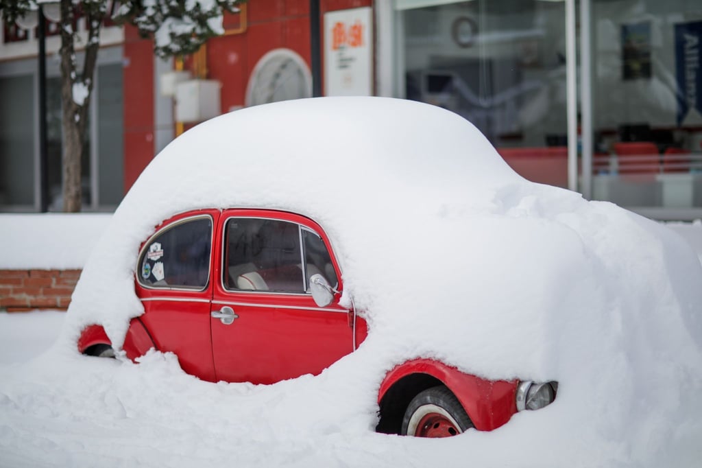 Ein Auto in Gaziantep am Straßenrand - bedeckt von einer dicken Schneeschicht.