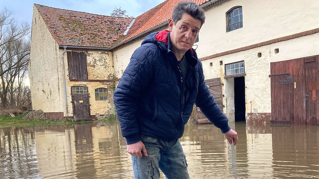 Miguel Stötzer überprüft regelmäßig den Wasserstand auf dem Hof der Angemühle in Hedersleben. 20 Zentimeter zeigt der Maßstab am Dienstagnachmittag an.