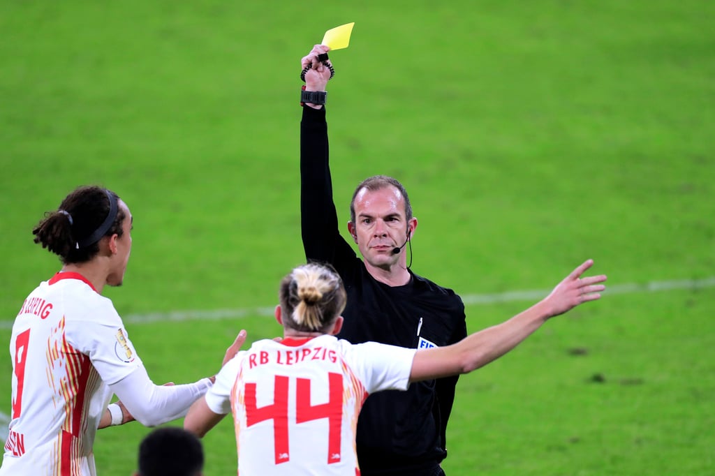 Schiedsrichter Marco Fritz zeigt Kevin Kampl im März 2021 gegen Wolfsburg die gelbe Karte.