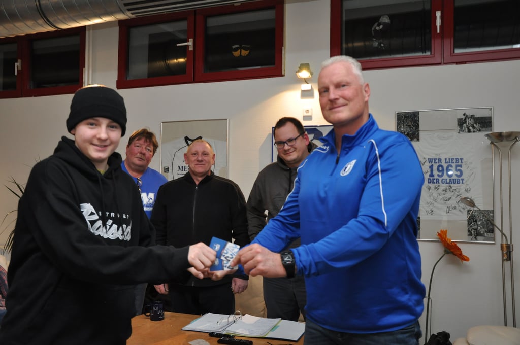 Olaf Daiker (r.) vom FCM-„FanRat“ überreicht Amon zum Dank für seinen Bolzplatz-Einsatz Karten für den Besuch eines der nächsten FCM-Heimspiele. Amon überrascht mit eigener Ausstattung; Vater und Sohn sind Dauergäste im Stadion. Die Karten nimmt er trotzdem gerne an; Mutti will auch mal mit und sicher noch ein Freund.