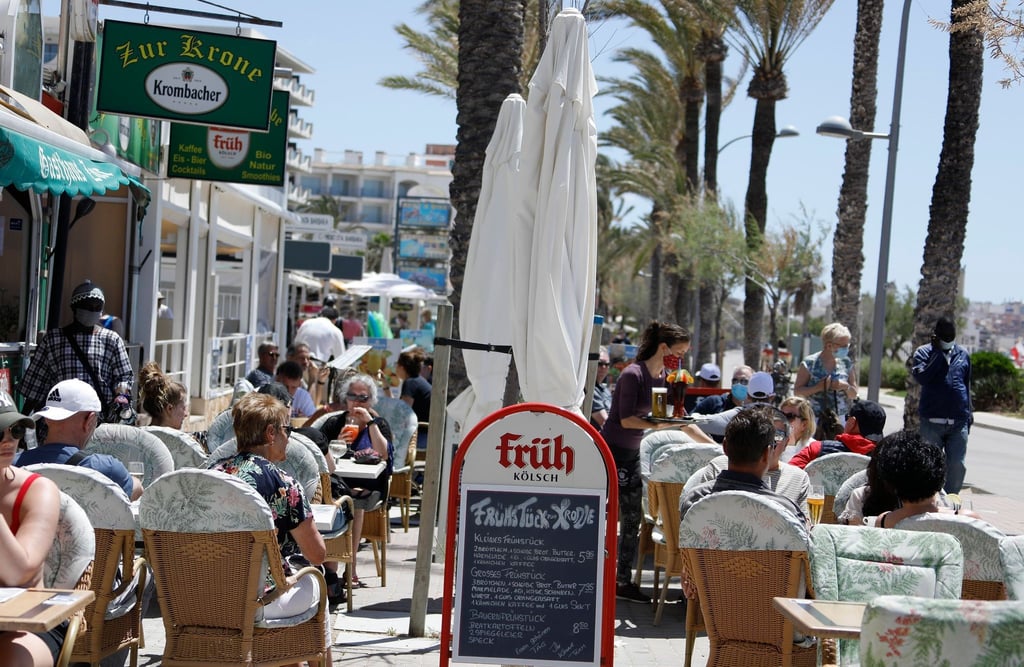 Kunden sitzen im Außenbereich einer Gaststätte in Palma.