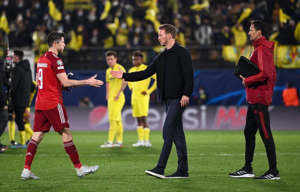 Münchens Trainer Julian Nagelsmann (M) nach dem Spiel in Villarreal beim Handschlag mit Robert Lewandowski.
