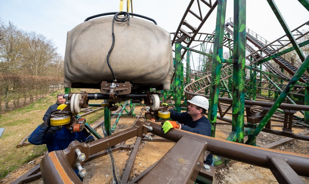 Mitarbeiter setzen im Serengeti-Park einen Achterbahnwagen auf die Schiene. Nach zwei Jahren mit Einschränkungen starten die Freizeitparks Serengeti und Heide Park Soltau am Samstag voll in die Saison.