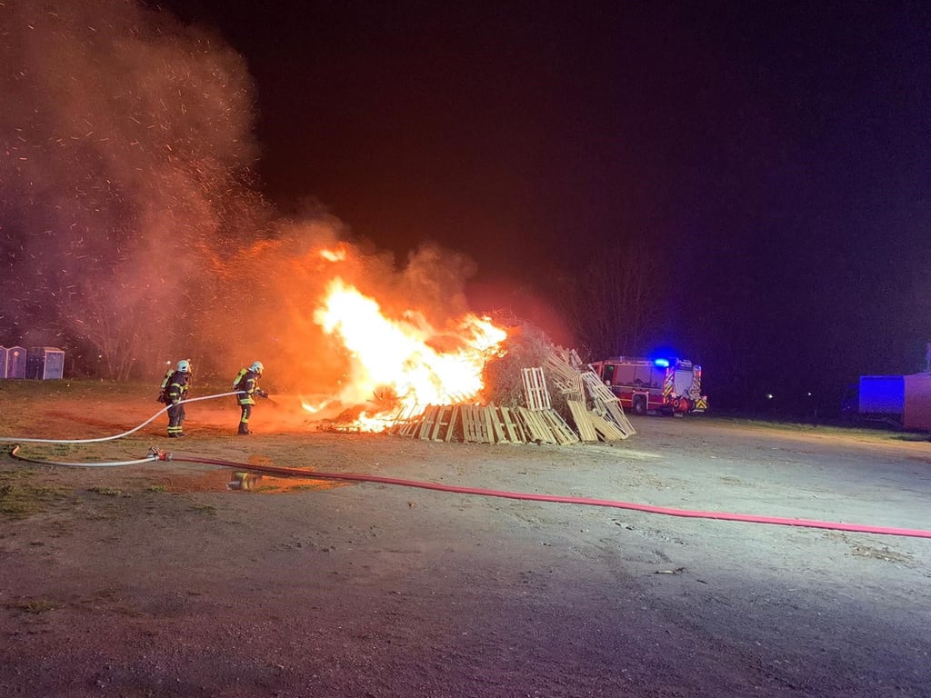 Feuerwehrleute beim Löschen des Osterfeuers.