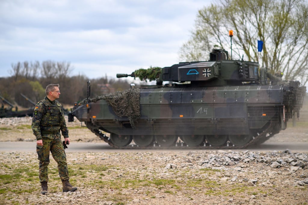 Ein Brigadegeneral beobachtet bei einer Bundeswehrübung die Verlegung seiner Panzer. Hinter ihm fährt ein Schützenpanzer vom Typ „Puma“.