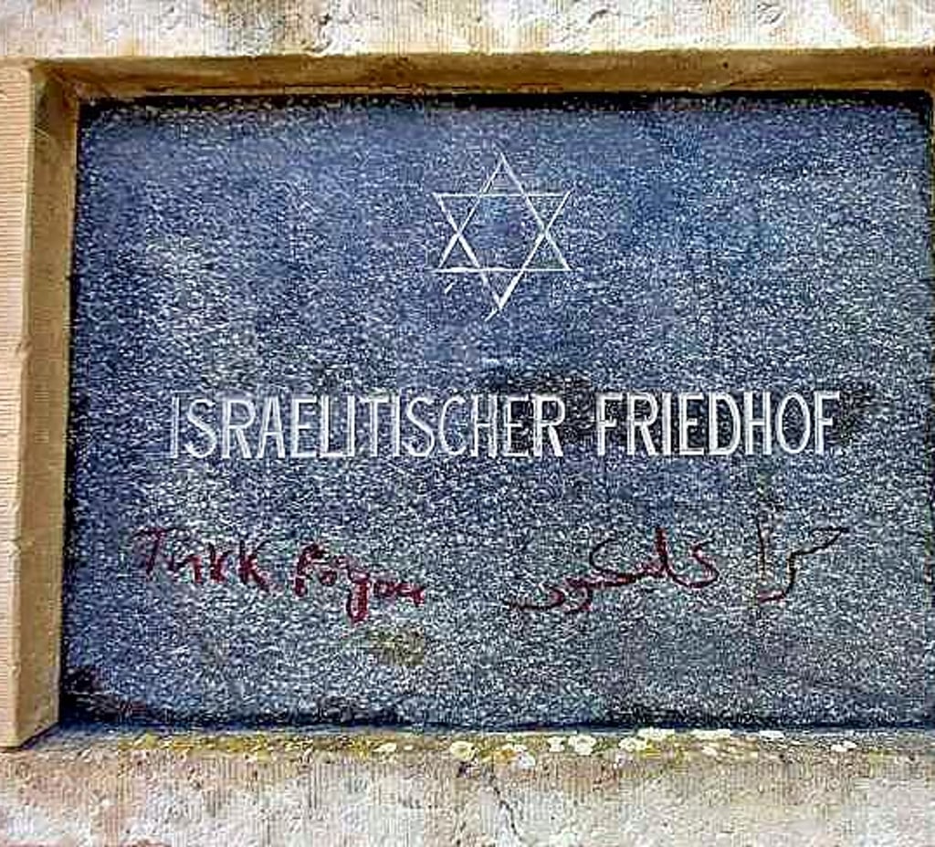 Die Tafel im Eingangsbereich des Friedhofs ist beschmiert.