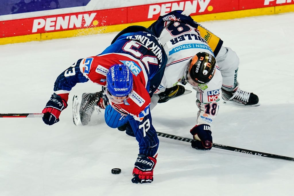 Mannheims Markus Hännikäinen (l) und Berlins Jonas Müller kämpfen um den Puck.