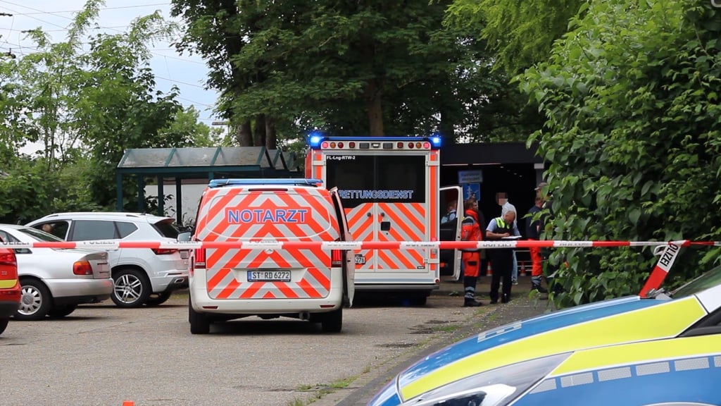 Notarzt und Polizei stehen auf einem Parkplatz in Lienen.