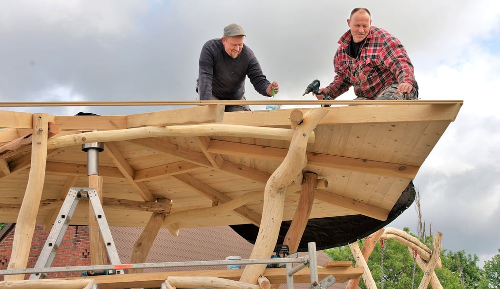 Tino Cebulski und Thomas Rulf zimmern das Dach für das Klettergerüst. Der Spieplatz in Hohenbellin entsteht in Eigeninitiative.