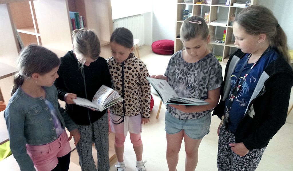 Lilly (links), Marlene, Bella, Ronja und Zoe schmökern bei ihrem Besuch des zukünftigen Leseclubs im Seehäuser Hort gleich aufmerksam in einigen Büchern.