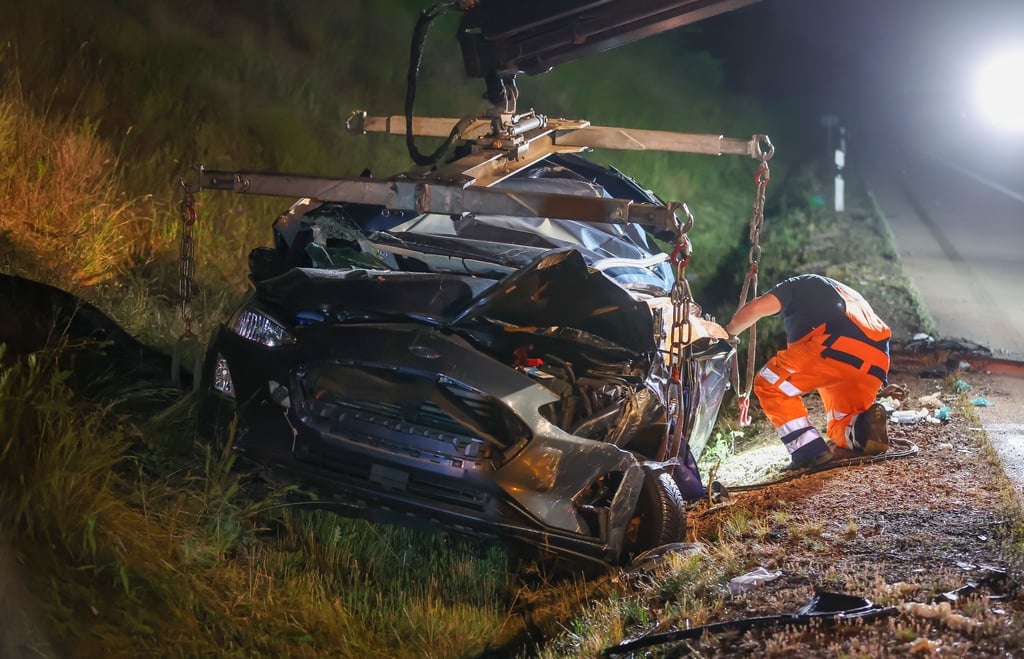 Am Donnerstagabend kam es auf der A14 bei Halle zu einem tödlichen Unfall. Ein Mitarbeiter eines Abschleppunternehmens bereitet das Wrack des Pkw für die Bergung vor.