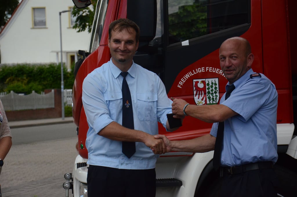 Stadtwehrleiter Sven Rasch (rechts) übergibt Gardelegens Ortswehrleiter Henrik Lehmann die Schlüssel.