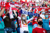 Fans mit Maske bei einem Heimspiel von RB Leipzig.