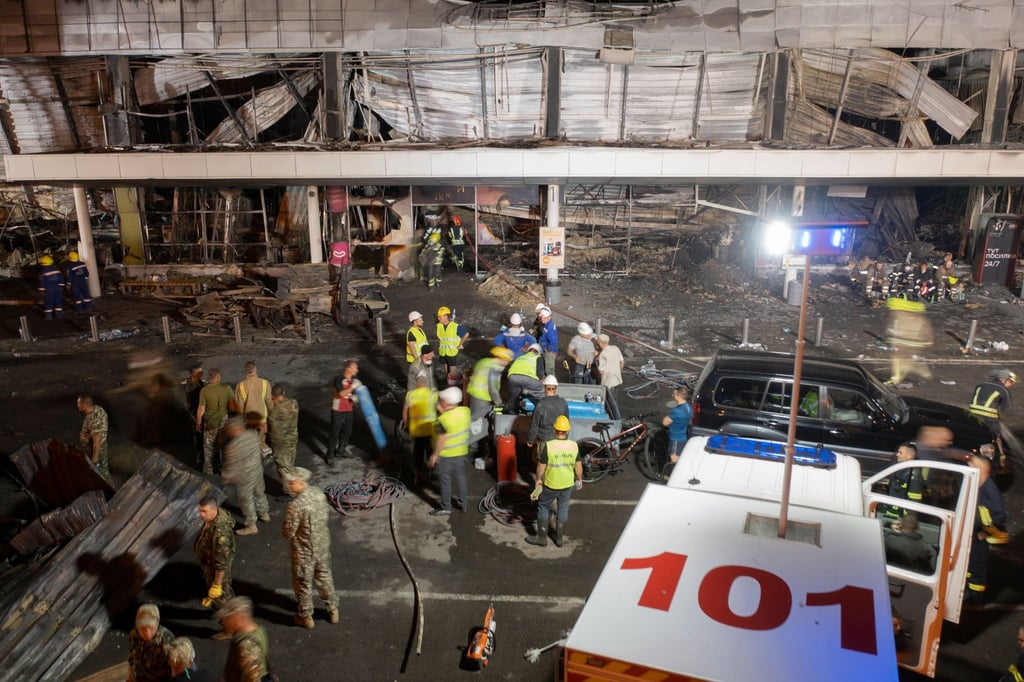 Feuerwehrleute bekämpfen den Brand in einem Einkaufszentrum nach einem Raketenangriff in Krementschuk.