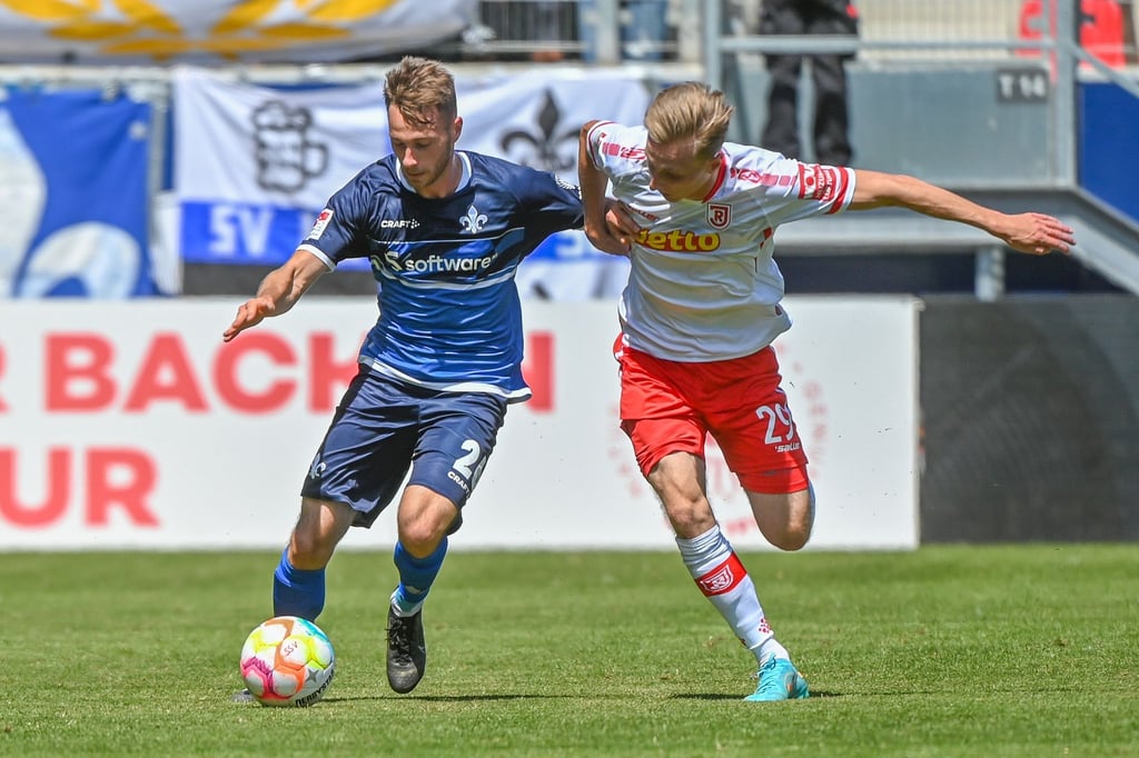 Jahn-Torschütze Joshua Mees (r) setzte sich mit Regensburg gegen Matthias Bader und Darmstadt 98 durch.