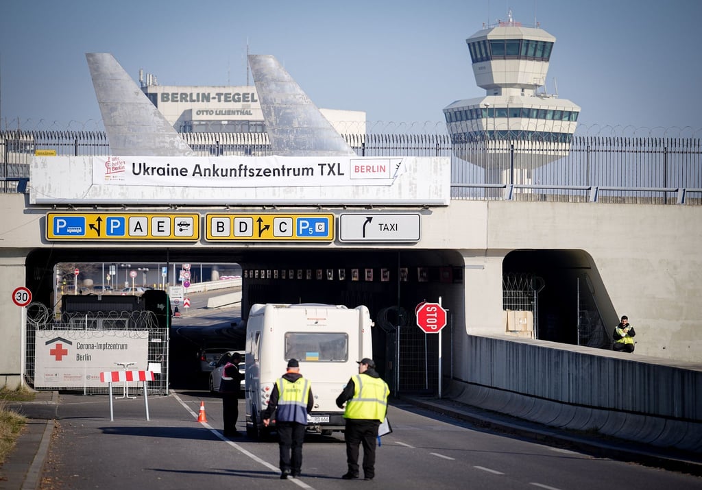 „Ukraine Ankunftszentrum TXL“, steht über der Zufahrt zum ehemaligen Flughafen Tegel.