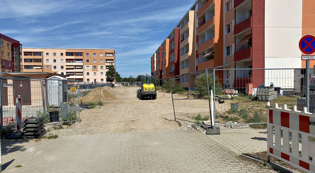 Die Mieter des Wohnblocks rechts in der Geschwister-Scholl-Straße in Jessen gelangen momentan durch die hinteren Eingänge nicht in die Fahrradräume. Sie müssen dafür den Haupteingang auf der anderen Seite nutzen. Dass die Gestaltung der Fläche länger dauert als veranschlagt, steht in der Kritik.