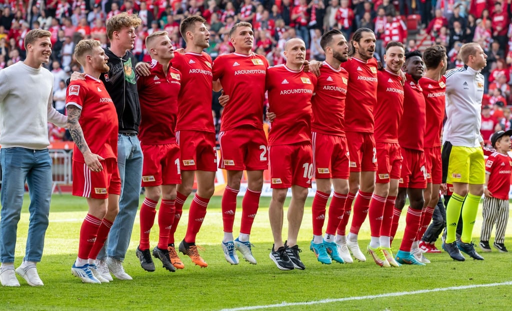 Die Spieler von Union Berlin feiern mit den Fans.