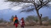 Zwei Massai-Frauen gehen zum Wahllokal der Oltepesi-Grundschule in Kajiado County, um ihre Stimme während der Präsidentschafts- und Parlamentswahlen in Kenia abgeben zu können.