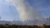 Rauch steigt aus einem Wald in Schierke auf. Seit den Mittagsstunden des Donnerstags brennt es im Nationalpark Harz.