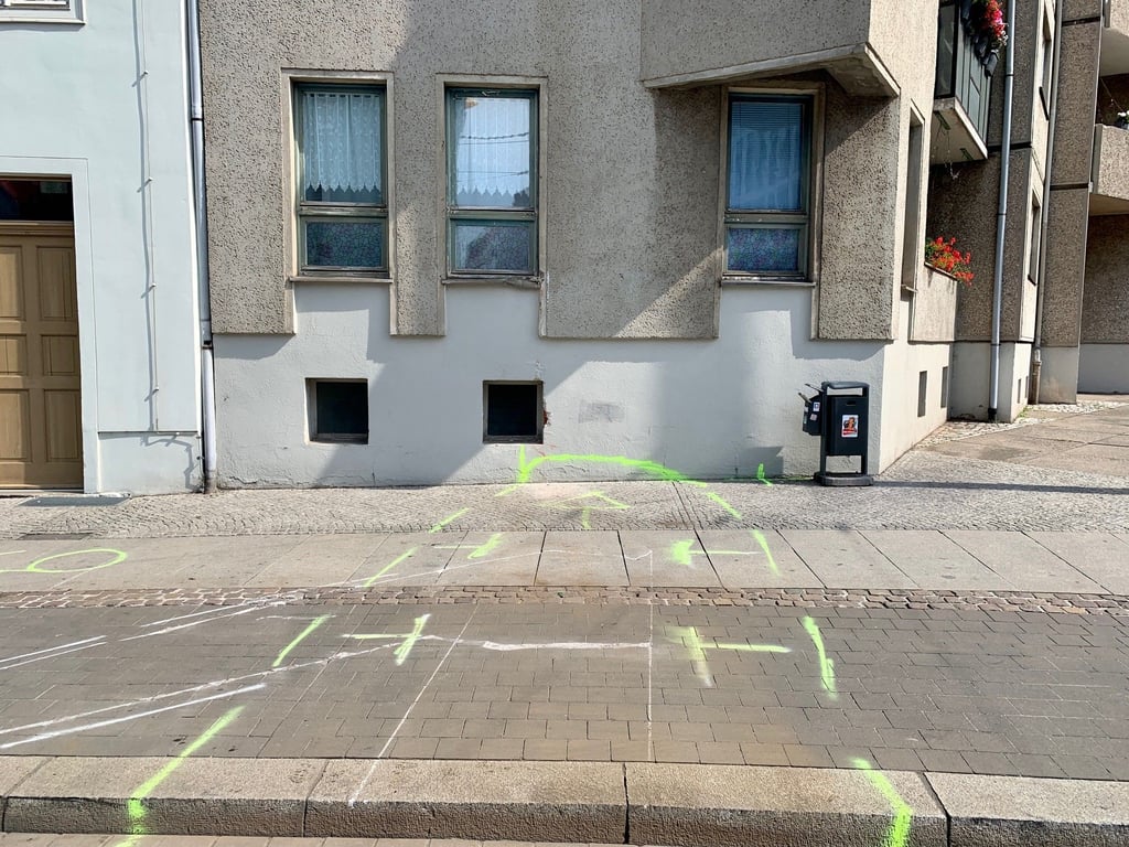 Markierungen der Polizei zeigen, wo der entgleiste Triebwagen gegen die Hauswand stieß.