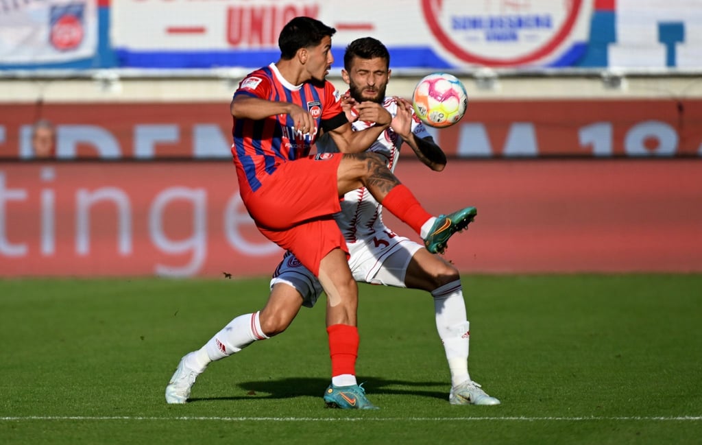 Heidenheims Kevin Sessa (l) und Düsseldorfs Nicolas Gavory kämpfen um den Ball.