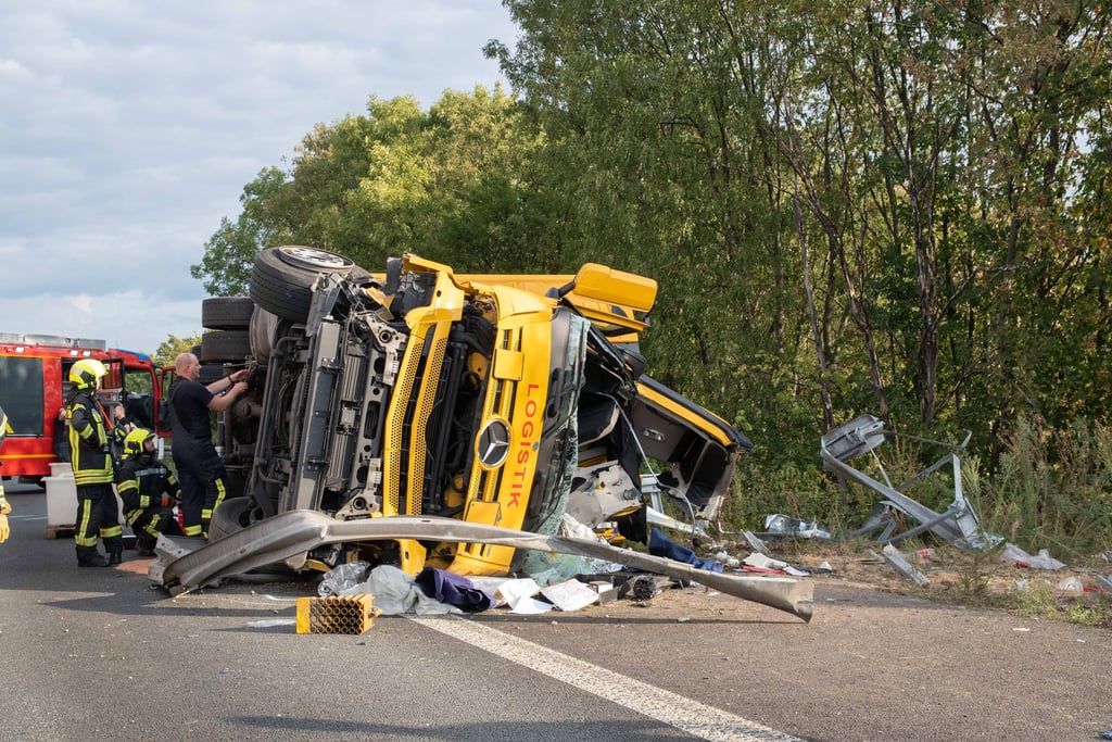 Einsatzkräfte arbeiten auf der A57 an dem umgekippten Sattelzug. Der Lkw war am Morgen von der Fahrbahn abgekommen, gegen einen Betonabweiser geprallt und dann auf dem Seitenstreifen liegen geblieben.