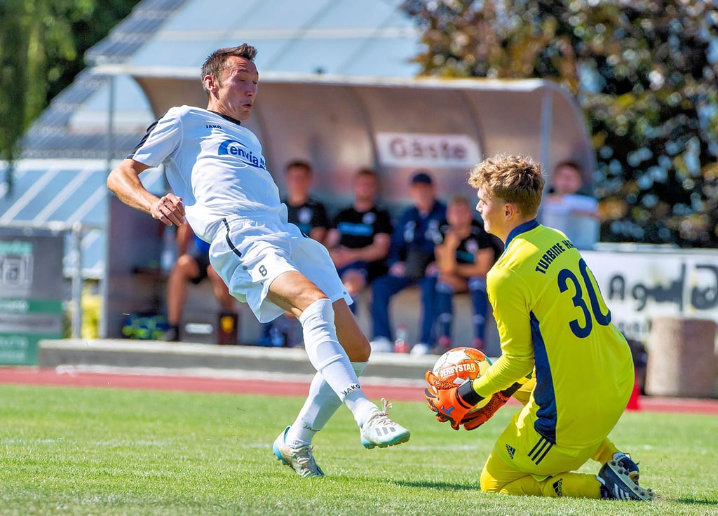 Der Lauchaer Maximilian Handt (L) kommt im Landespokalspiel gegen Turbine Halle einen Schritt zu spät. Gästekeeper Jonas Bergner kann den Ball sichern. Das BSC-Team verliert knapp mit 1:2 und scheidet aus.