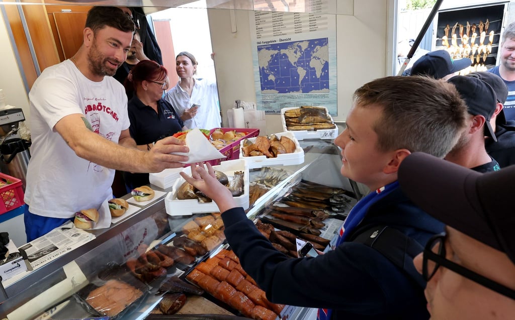 Rapper Marteria verschenkt auf der Warnemünder Mole rund 500 Fischbrötchen an seine Fans.