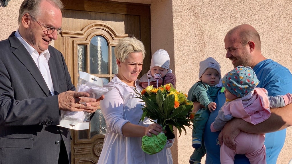 Ministerpräsident Reiner Haseloff ist Ehrenpatenonkel von Lili, Chris und Zoe (von links). Nadine und Michael Olm freuen sich über die prominente Unterstützung.
