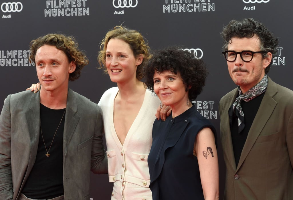 Die Schauspieler Aaron Friesz, (v.l.n.r) die Schauspieler Vicky Krieps, die Regisseurin des Eröffnungsfilm „Corsage“ Marie Kreutzer, und der Schauspieler Manuel Rubey, stehen beim Filmfest Munich im Juni in der Isarphilharmonie auf dem Roten Teppich.