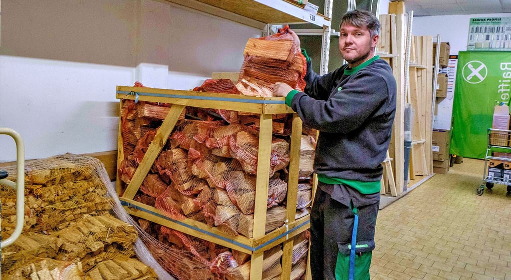 Raiffeisenmarkt Oranienbaum: Alexander Fuhrmann am Holzstapel. Braunkohle gehört auch hier zur Mangelware.