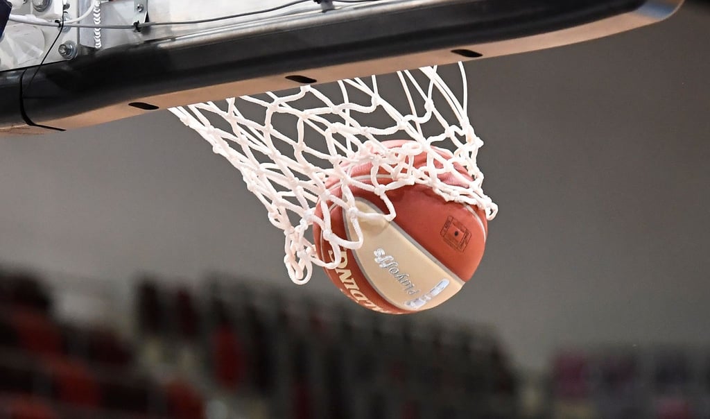 Ein Basketball landet im Korb.
