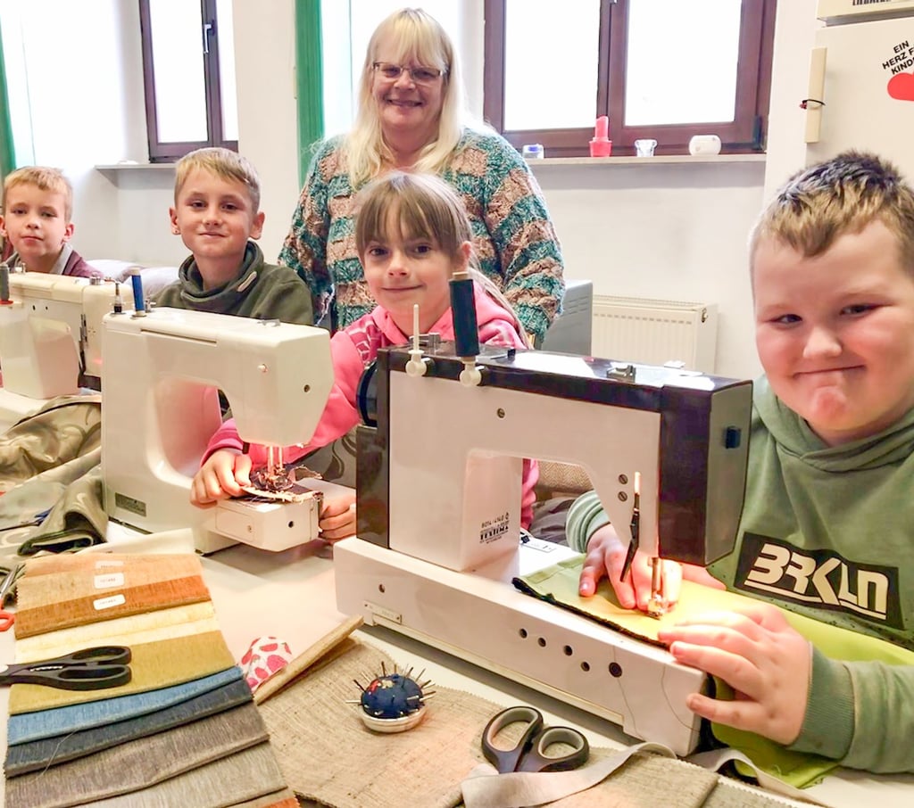 Cornelia Meinecke (Mitte) bietet im Rathaus Sandersleben ehrenamtlich einen Nähkurs für Kinder an. Adrian, Tim, Emma und Luca (v.li.) sind regelmäßig da und haben schon die ersten eigenen Stücke wie Taschen und Kissen genäht.