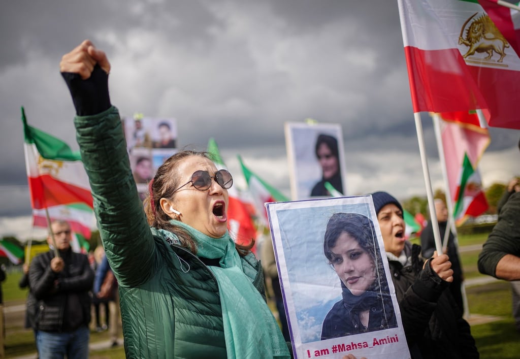 Mit Plakaten von Masha Amini demonstrieren Teilnehmer für Demokratie und Freiheit im Iran.
