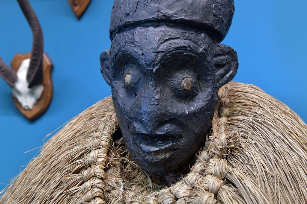 Eine Kopfaufsatzmaske aus Kamerun ist in einer Vitrine im Bremer Überseemuseum ausgestellt.