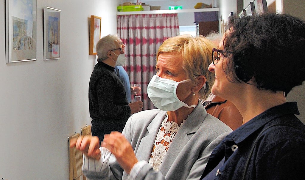 Anette Petereit (links) erläuterte den Besuchern der Ausstellungseröffnung ihre Bilder, die in den nächsten drei Monaten in der Beetzendorfer Arztpraxis zu sehen sind.
