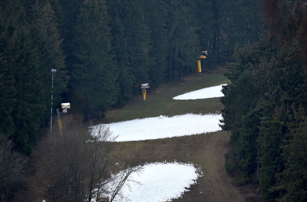 Auf einem Hang liegt teilweise von Schneekanonen produzierter Schnee.