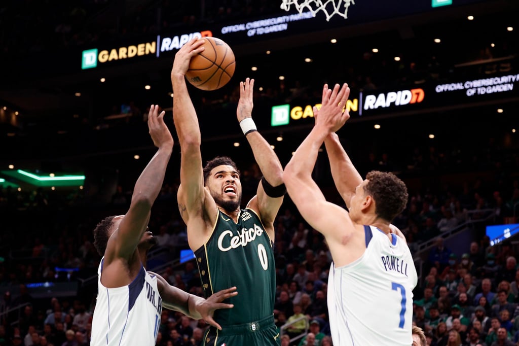 Bostons Jayson Tatum (0) zieht zum Korb zwischen Dorian Finney-Smith (l) und Dwight Powell von den Dallas Mavericks.