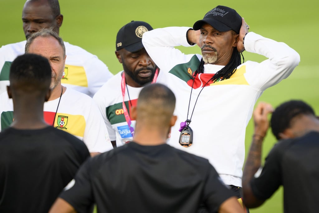 Kameruns Cheftrainer Rigobert Song (r) steht mit der Nationalmannschaft auf dem Trainingsplatz.