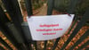 Ein Schild mit der Aufschrift "Gefügelpest. Unbefugter zutritt verboten!" hängt an einem Tor.