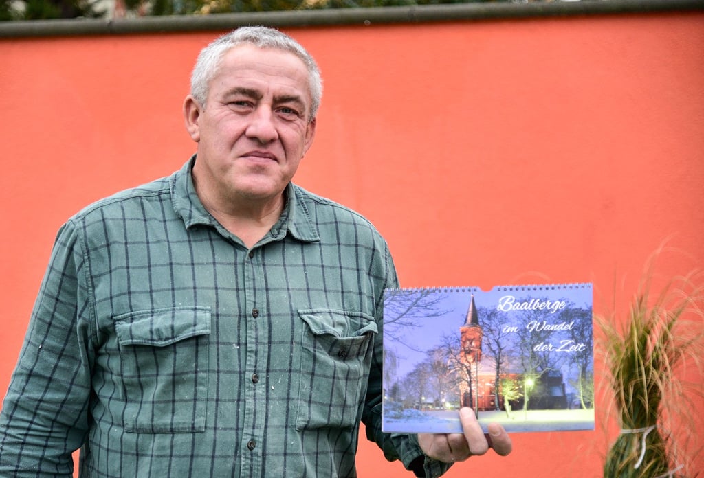 Ortsbürgermeister, Hobbyfotograf und Chronist − Heiko Scharf präsentiert den neuen Baalberge-Kalender für 2023.
